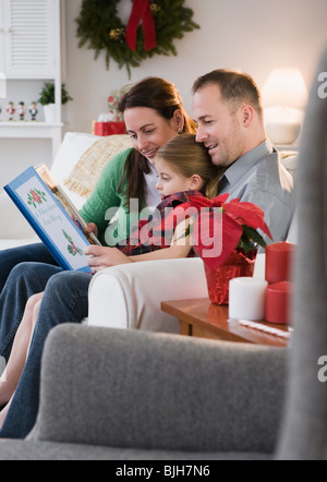 Eltern, die Tochter lesen Stockfoto