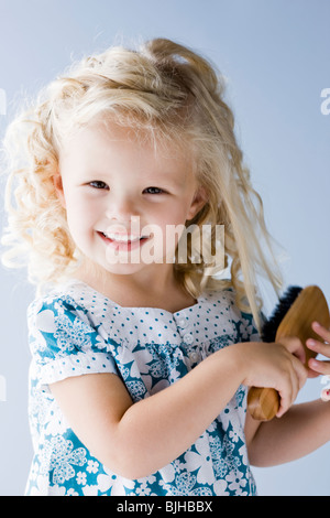 kleines Mädchen, die ihr Haar Bürsten Stockfoto