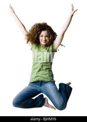 woman jumping with her arms raised in the air Stockfoto
