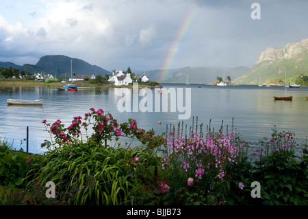 Blick über Plockton Bay mit Regenbogen und Blumengarten Stockfoto