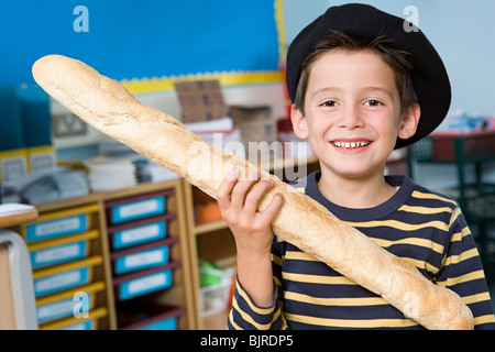 Boy Holding baguette Stockfoto