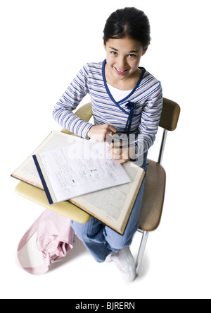 Schülerin am Schreibtisch Stockfoto