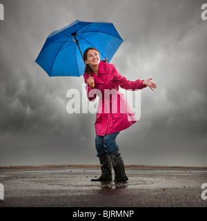 USA, Utah, Orem, Frau mit Sonnenschirm stehen in Pfütze Stockfoto