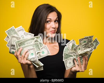 Glückliche Frau hält US-Dollarnoten Stockfoto