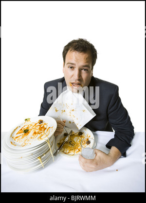 Geschäftsmann, fressen sich auf Spaghetti mit Übergewicht Stockfoto