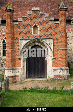 Tudor aus rotem Backstein Veranda gegen weitere antike Gebäude, St.-Peter Kirche, Charsfield Suffolk Stockfoto