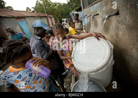Bewohner von Mirebalais, Haiti holen sauberes Trinkwasser aus einer Quelle. Stockfoto