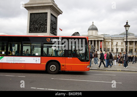 Eine rote Arriva London Bendybus übergibt Nelsonsäule in London Trafalgar Square mit der National Gallery im Hintergrund Stockfoto