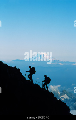 Zwei Kletterer aufsteigend Mount Rainier mit Mount Adams am Horizont, Mount-Rainier-Nationalpark, Washington. Stockfoto