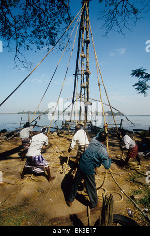 Fischer auf die chinesischen Fischernetze In Fort Cochin Kerala Indien Stockfoto