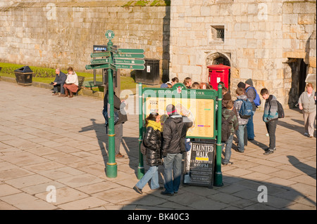 Touristen in York UK konsultieren Straßenkarte Reiseführer Stockfoto