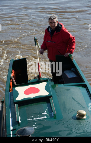 Mann an Spitze der schmalen Boot Lenkung Stockfoto