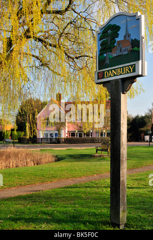 DANBURY, ESSEX, Großbritannien - 10. APRIL 2010: Dorfschild mit Village Green und Duck Pond im Hintergrund Stockfoto