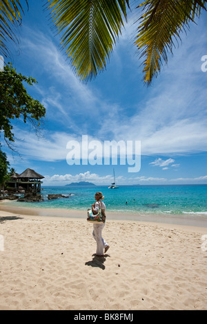 Frau zu Fuß auf einem Strand in der Nähe von Glacis, Mahé, Seychellen, Indischer Ozean, Afrika Stockfoto