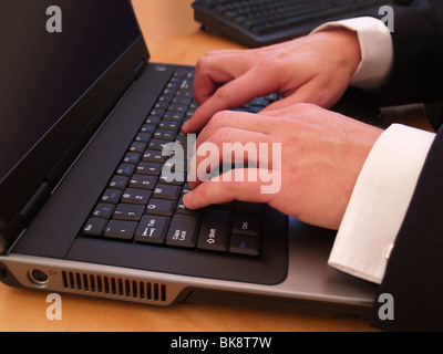 Nahaufnahme eines Mannes Hände Tippen auf einen laptop Stockfoto
