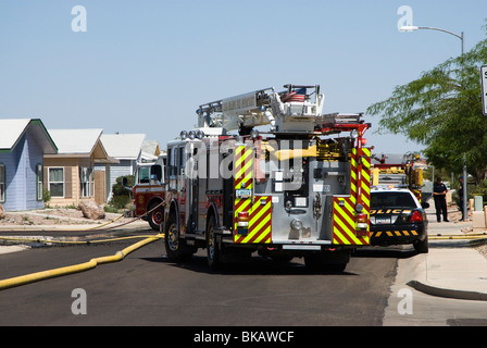 Feuerwehrleute reagieren auf einen Hausbrand in einem Wohngebiet Stockfoto