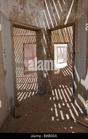 Licht dringt durch die alten Dielen, die Schatten und interessante im Haus Ingenieure, Kolmanskop in der Nähe von Lu Muster Stockfoto