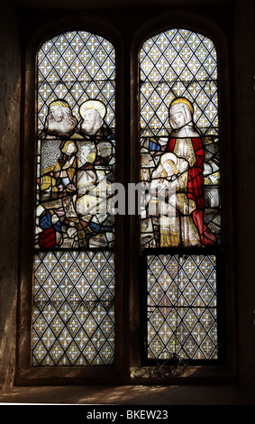 Ein mittelalterlicher Glasfenster, die Darstellung von Jesus und anderen Heiligen (links) und Sankt-Anna-Lehre der Jungfrau Maria zu lesen Stockfoto