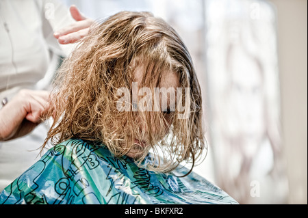 Ein kleiner Junge einen überfälligen Haarschnitt bekommen! Stockfoto