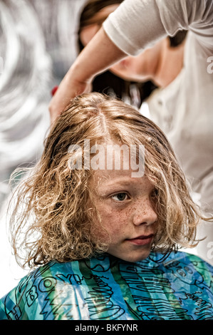 Ein kleiner Junge einen überfälligen Haarschnitt bekommen! Stockfoto