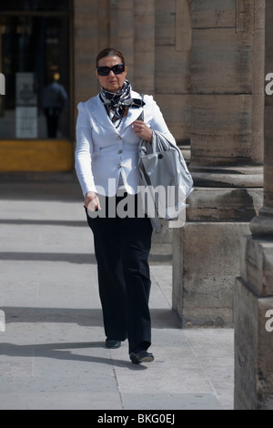 Modische Frau Promenierenden im Gewölbe der "Jardin du Palais Royale' historischen Arcade in Paris, Frankreich mit Sonnenbrille Stockfoto