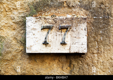 Blocknummer an eine verwitterte Wand Stockfoto