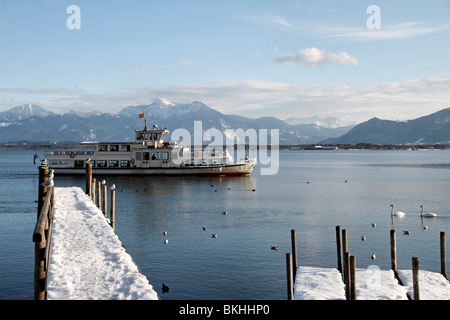 Fähre Boot Barbara vorbei an schneebedeckten Pier am Chiemsee, Chiemgau, Upper Bavaria Germany Stockfoto