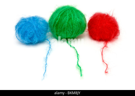 A line up of red, green and blue balls of mohair wool isolated against white background. Stockfoto