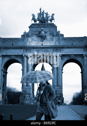 Belgien, Brüssel; Ein Mädchen mit einem Regenschirm vor dem Arc du Triomphe Stockfoto