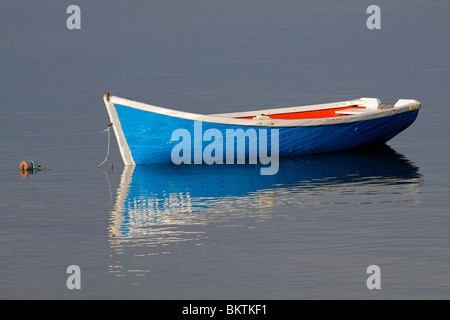 Verankerte hölzernen Fischerboot mit Spiegelung im Wasser Stockfoto