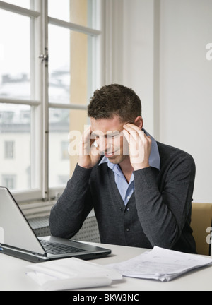 Unruhigen Geschäftsmann mit laptop Stockfoto