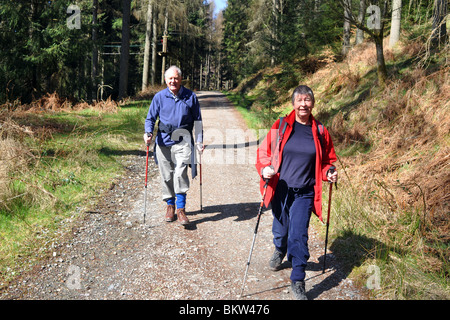 Aktive ältere Menschen gehen Bergwandern in the Trossachs National Park, Schottland Stockfoto