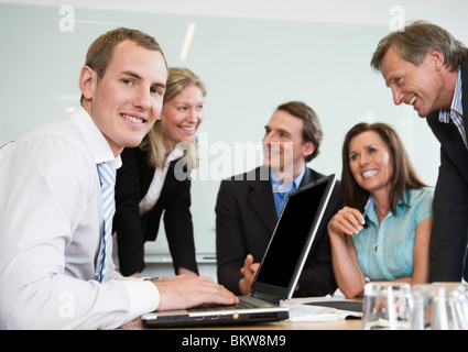 Fünf Personen durch Konferenztisch Stockfoto