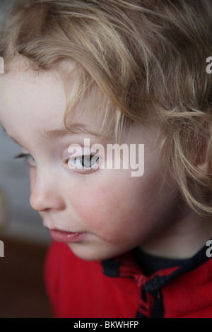 ZWEI JAHRE ALT, die MISSTRAUISCH AUSSEHEN: Zwei Jahre altes Kind, das ein lustiges Gesichtsmodell macht, wurde entlassen Stockfoto