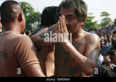 Ein Mann im Gebet Wai Kru tagsüber am Wat Bang Phra, ein buddhistischer Tempel in Thailand, wo Mönche Anhänger tattoo. Stockfoto