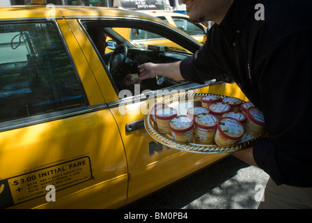 Mitarbeiter der Håågen-Dazs Eis verteilen kostenlose Proben außerhalb eines Supermarktes in New York Stockfoto