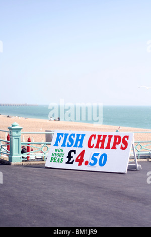 Fish And Chips und Erbsenpüree für £4,50 in Brighton Beach. am Meer-pier Stockfoto