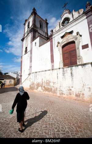 Alte Frau vor Misericordia Kirche, Stadt Silves, Bezirk Faro, Region der Algarve, Portugal Stockfoto