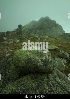 Ein verkeilten Felsen im Hinblick auf einen Nebel verhüllt North Rams Head, Kosciuszko-Nationalpark, New South Wales Australien Stockfoto