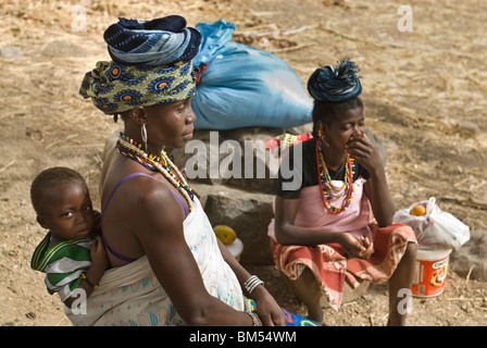 Afrikanische Bedik Frau mit einem Kind, ruht auf dem Weg zum Dorf Iwol, Bassari-Land, Senegal, Afrika. Stockfoto