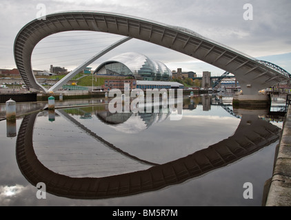 Millennium Bridge am Fluss Tyne Gateshead Winking Auge dem Erdboden gleichgemacht mit Spiegelbild im Fluss Tyne Salbei im Hintergrund Stockfoto