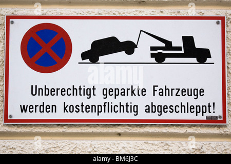 Ein Schild warnt die Menschen, dass falsch geparkte Autos in München, Bayern, abgeschleppt werden. Stockfoto