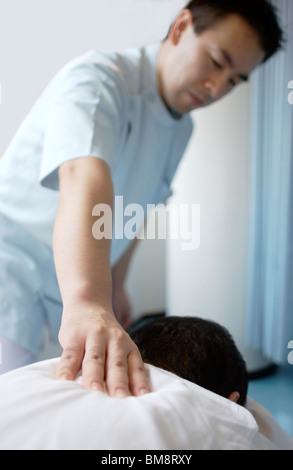 Massage der Therapeut massiert Mann zurück Stockfoto