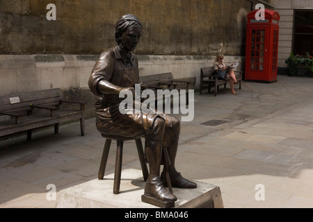 Die Cordwainer Statue und eine Dame Stadt Arbeitskraft ruht auf einer Bank im Watling Street, City of London. Stockfoto