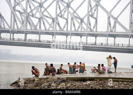 Aktivitäten auf Babu Ghat; Howrah Brücke über Hooghly Fluß im Hintergrund; Calcutta jetzt Kolkata; Westbengalen; Indien Stockfoto