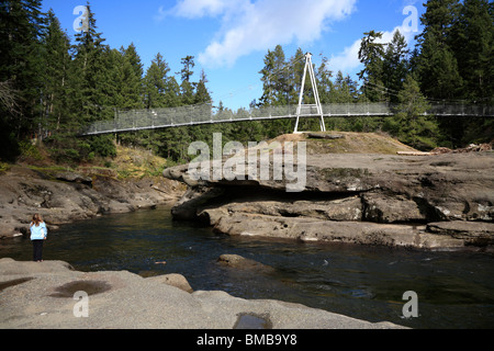 Ein Kind an der Spitze der Englishman River Gorge und Hängebrücke in der Nähe von Parksville auf Vancouver Island, BC Kanada Stockfoto