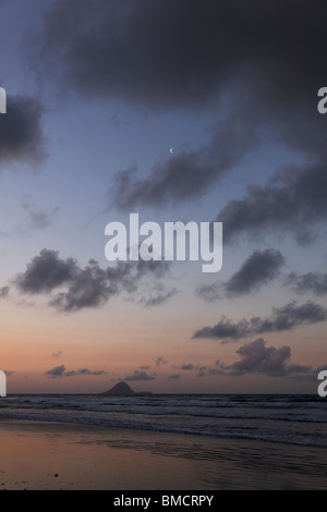 Ein Sonnenuntergang über Ohope Beach mit Whale Island und dem Mond im Hintergrund, Neuseeland Stockfoto