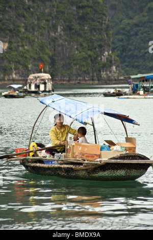 Mutter und Kind, Verkauf von Essen und Trinken von Rudern Boot in der Halong Bucht, Vietnam Stockfoto