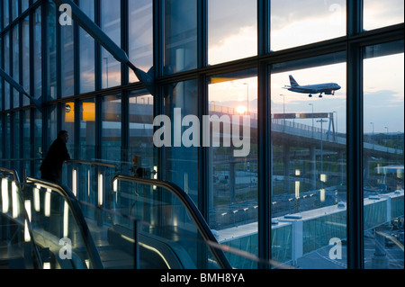 London Heathrow Airport Terminal 5 - Abflug-Gate bei Sonnenuntergang - BA Crew-Mitglied Uhren einen Abend BA Abreise Stockfoto