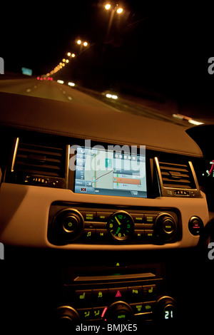 Innenraum des Range Rover Auto zeigt sat Nav und wählt auf Dashboard in der Nacht auf der Autobahn. UK Stockfoto